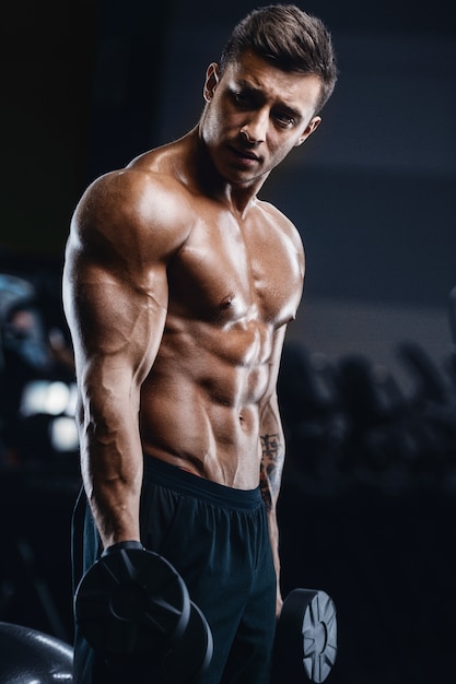 Sport muscular fitness man working out at the gym