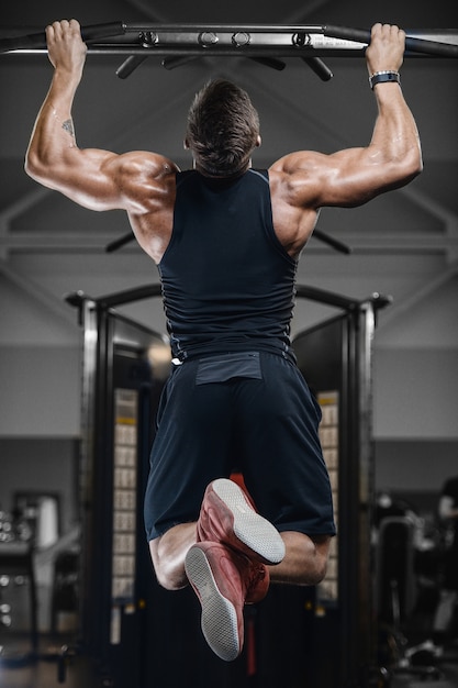 Sport muscular fitness man working out at the gym