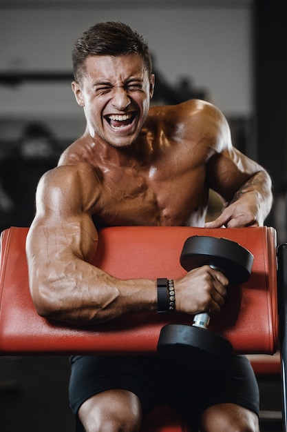 Sport muscular fitness man working out at the gym