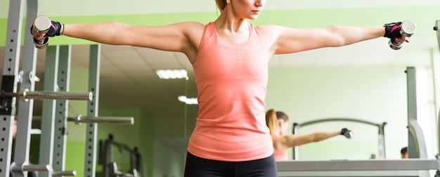 Photo sport and recreation concept - sporty woman hands with dumbbells.