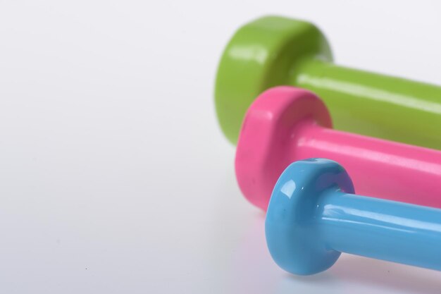 Sport regime symbols Barbells in pink green and blue colors