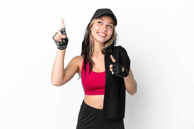 Sport Russian girl with hat and towel isolated on white background pointing with the index finger a great idea