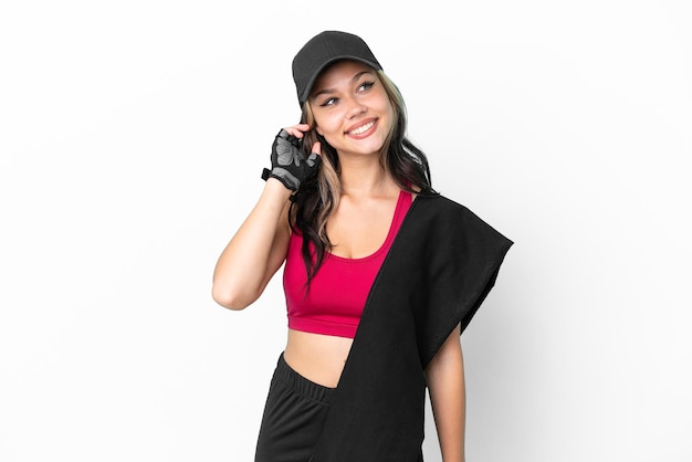 Sport Russian girl with hat and towel isolated on white background thinking an idea