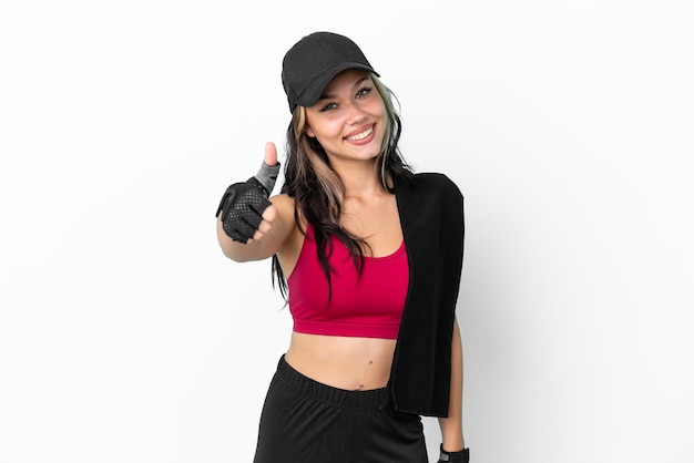 Sport Russian girl with hat and towel isolated on white background with thumbs up because something good has happened