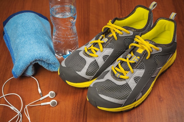 Sport shoes towel and water on the floor