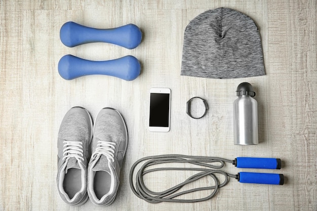 Sport sneakers and equipment on wooden background