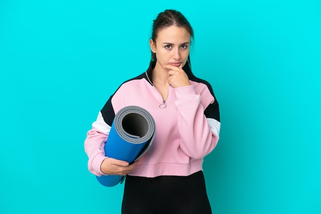 Sport Ukrainian woman going to yoga classes while holding a mat thinking