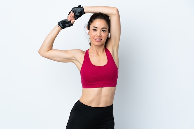 Sport woman over isolated white wall stretching