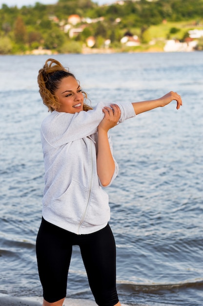 Sport woman making stretching before running 