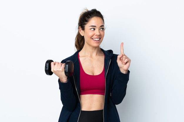 Sport woman making weightlifting over isolated white intending to realizes the solution while lifting a finger up