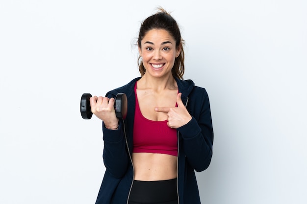 Sport woman making weightlifting over isolated white wall with surprise facial expression