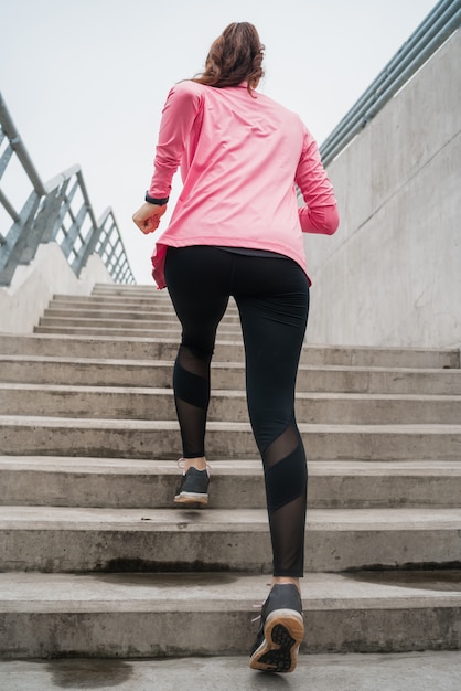 Sport woman running on stairs.