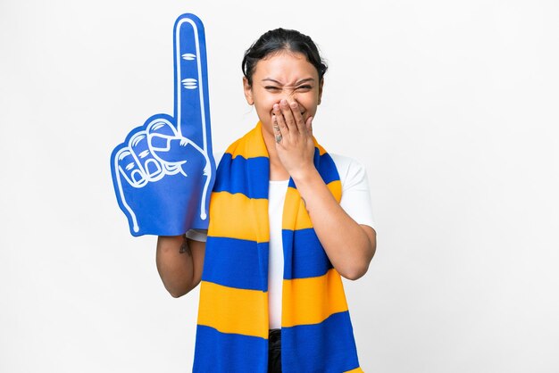 Sportfan vrouw over geïsoleerde witte achtergrond gelukkig en glimlachend bedekt mond met hand