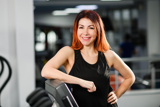 Sportive fit woman portrait in gym interior