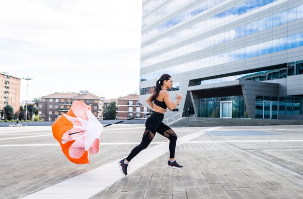 Sportive girl with fit body training outside 