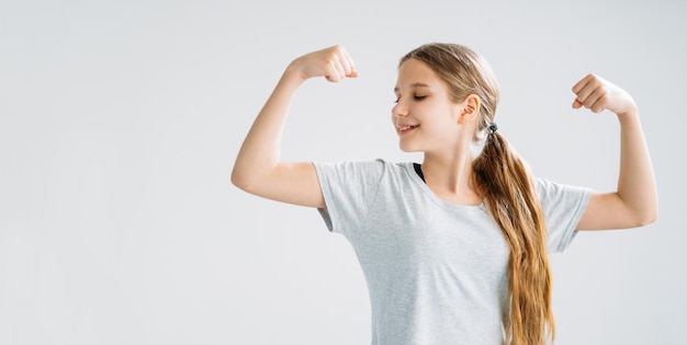 Sportive kids fitness banner girl showing biceps