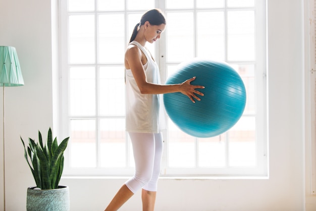 Sportive woman training at home