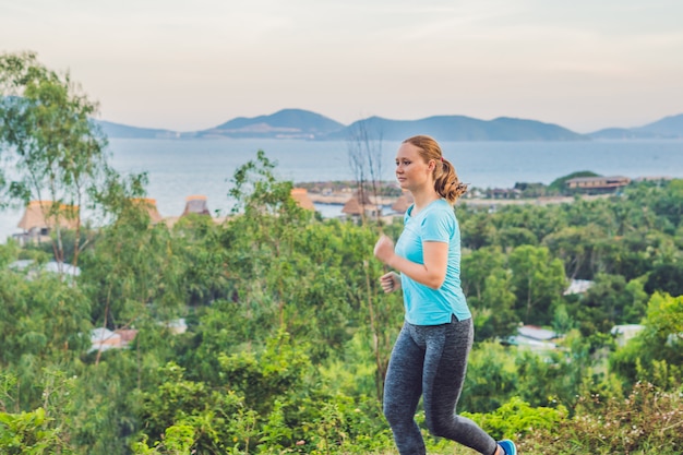 A sportive young woman running outside