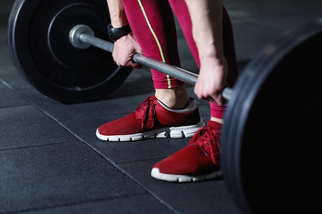 Sportman bereidt zich voor om te trainen met barbell in de sportschool