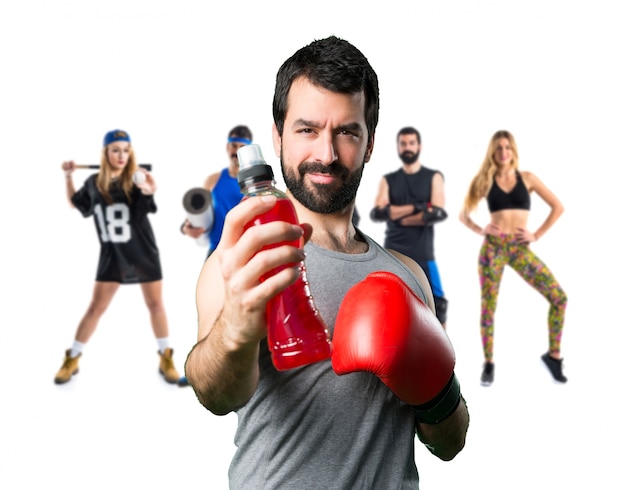 Sportman with boxing gloves drinking water soda