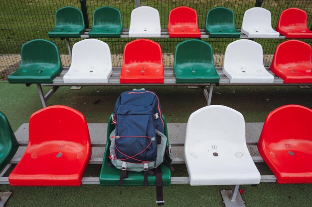 A sports backpack lies on the sports ground. Playground. Tribunes.