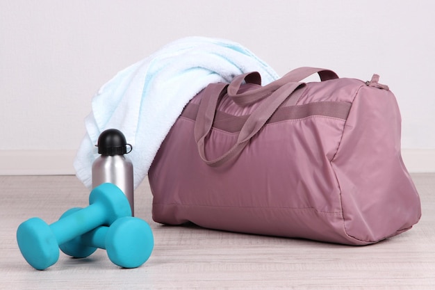 Photo sports bag with sports equipment in gymnasium