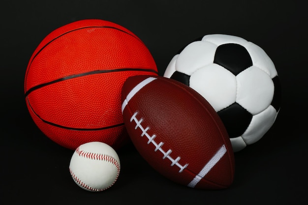 Sports balls on black background