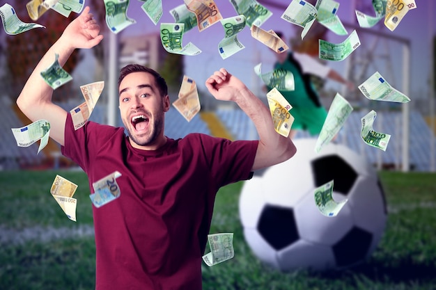 Sports betting Emotional winner under money shower Stadium with ball on background