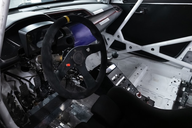 Sports car steering wheel, inside of a competitive vehicle.