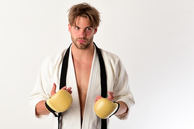 Sports and combat concept Guy poses in white kimono