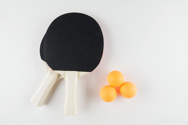 Photo sports composition ping pong close up rackets and ball for playing on a white background