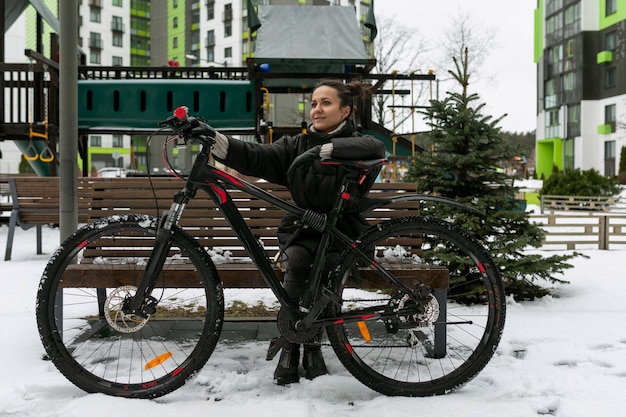 Sports concept a young woman rented a bicycle and rides it along the city street