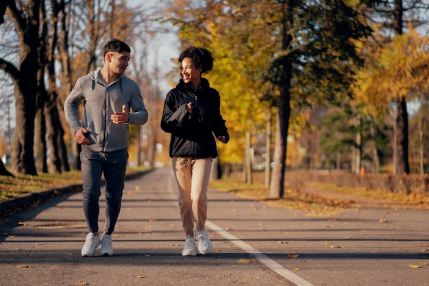 Sports couple in the park in the morning Heart training cardio system in the fresh air useful