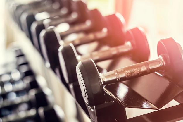 Sports dumbbells in the fitness room closeup training is the concept of a healthy lifestyle