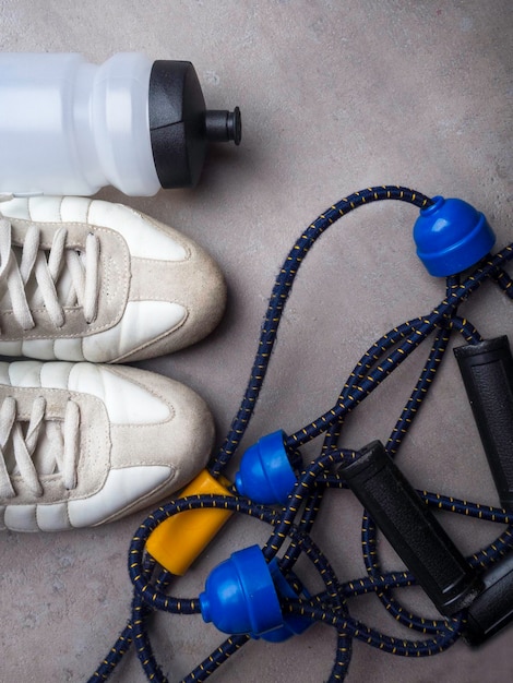 Sports equipment on grey background Top view Motivation