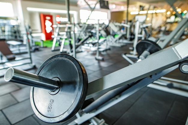 Sports equipment in a modern gym barbells of different weights on the rack