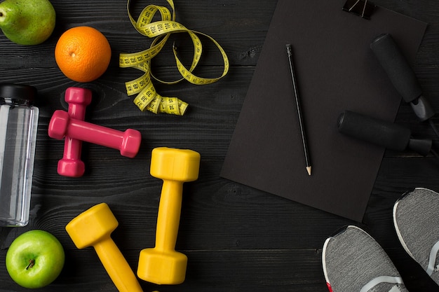 Sports equipment and wear on dark wooden background top view