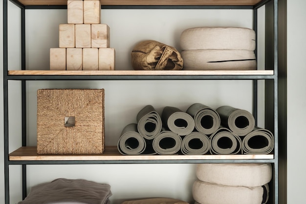 Photo sports equipment for yoga classes is on the shelf in the gym.