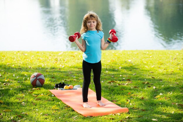 Free Photo  Girl stretching feet with a yellow resistance band on the yoga  mat in a lawn