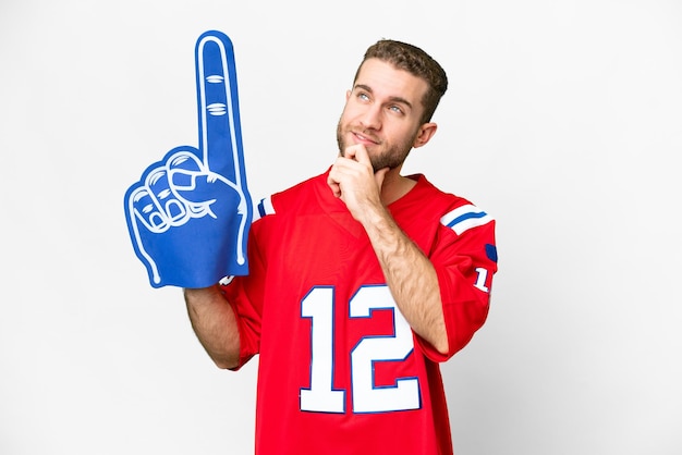 Photo sports fan man over isolated white background and looking up