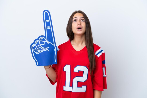 Sports fan Ukrainian woman isolated on white background looking up and with surprised expression