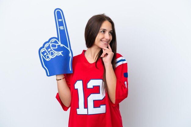 Sports fan Ukrainian woman isolated on white background thinking an idea while looking up