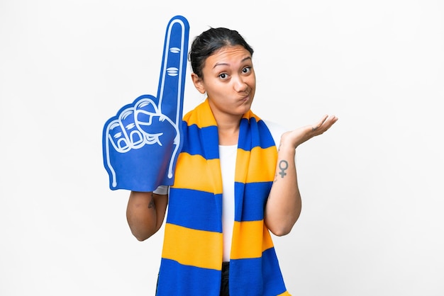 Sports fan woman over isolated white background having doubts while raising hands