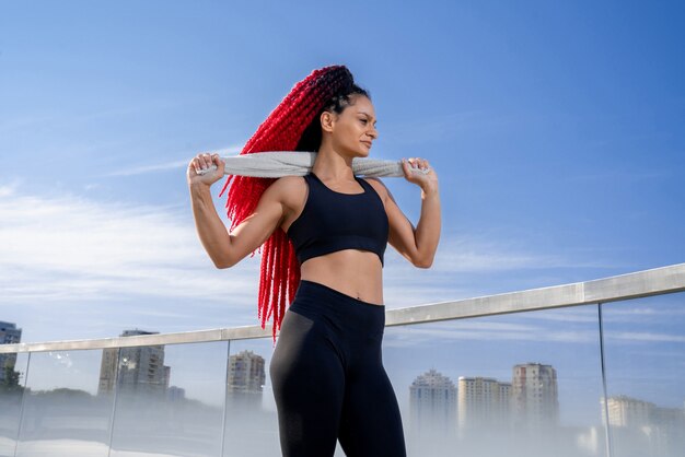 Sports girl, girl in sportswear, outdoor workout, Woman in sports tops, Black clothing for sports, girl with dreadlocks, girl with towel