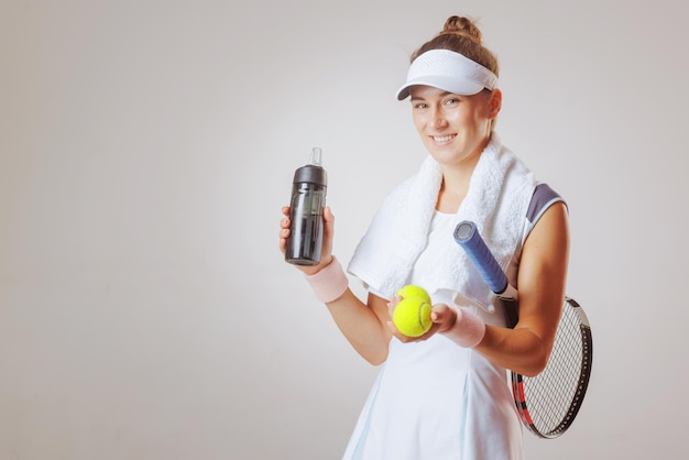 sports girl tennis player in a light uniform with a tennis racket on a clean background the concept of tennis