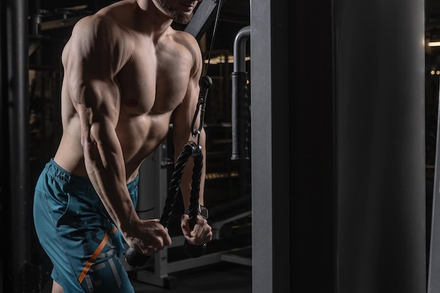 Sports guy is engaged on the simulator in the gym the concept of doing sports