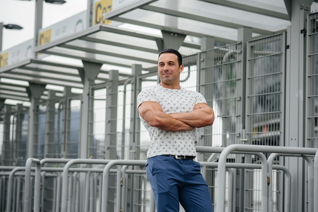 A sports guy stands and enjoys a walk near the stadium. Lifestyle