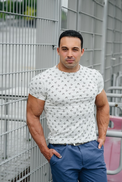 A sports guy stands and enjoys a walk near the stadium. Lifestyle