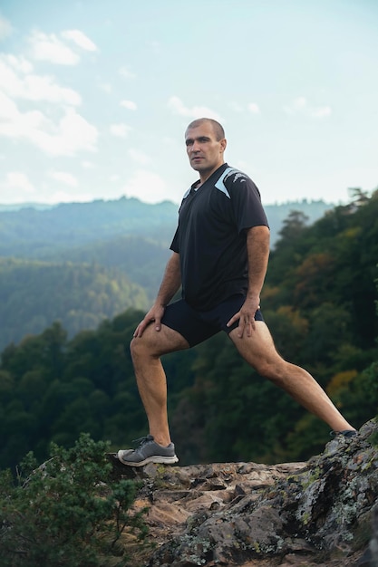 Sports man actively spends leisure time in the mountains