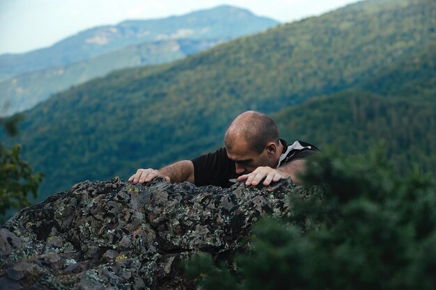 Sports man actively spends leisure time in the mountains